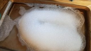 Baking sheet in soapy water
