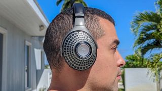 Listing image showing reviewer wearing Focal Bathys for best audiophile headphones