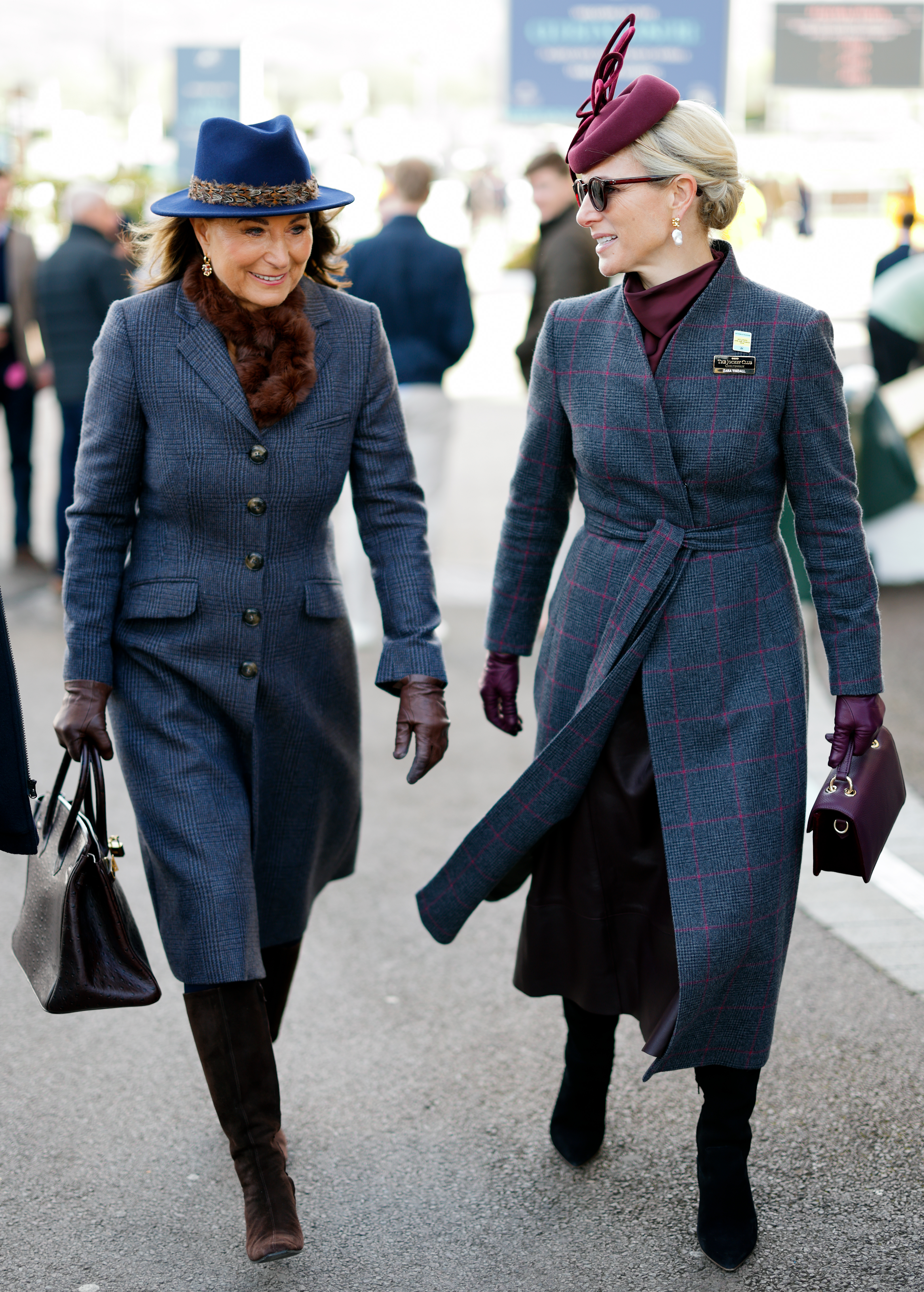 Carole Middleton walking next to Zara Tindall in a gray coat