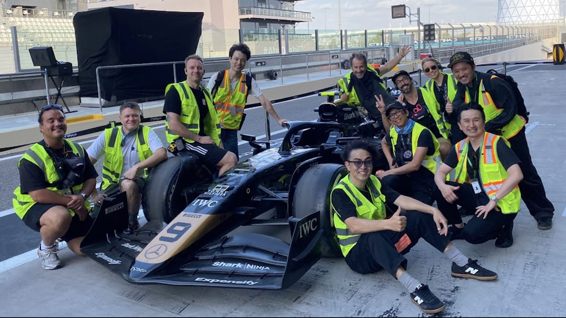 Sony&#039;s camera engineering team pose in front of an F1 car for the F1 movie.