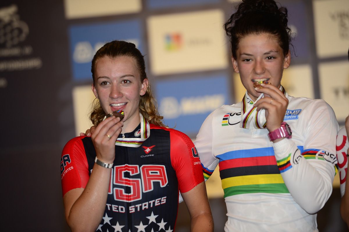Emma White and Chloe Dygert kiss their second set of medals from the Worlds