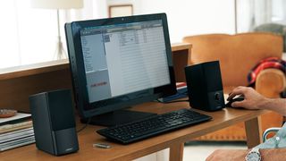 Hero image for best computer speakers showing Bose Companion 2 Series III connected to laptop
