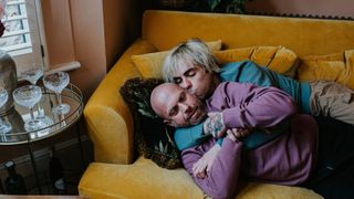 couple spooning on a couch in their living room