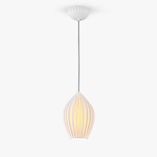 A modern pendant light featuring a white ribbed ceramic shade with a soft, warm glow emanating from within