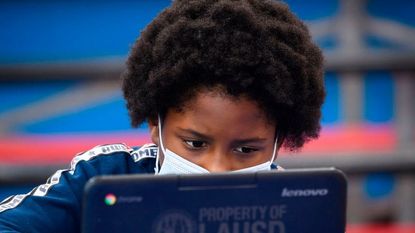 A student wears a mask inside their classroom.