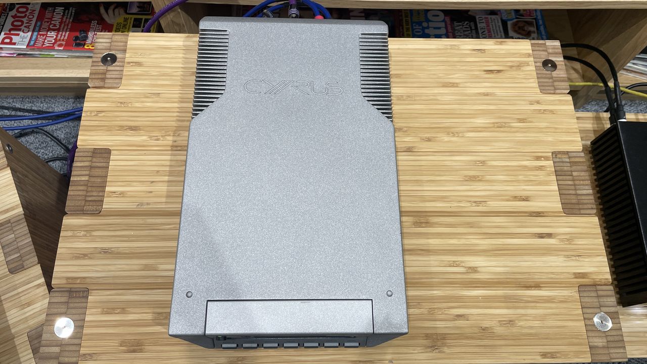 Cyrus CDi player on wooden rack with magazines in background