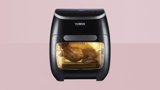 Tower 10-in-1 Air Fryer Xpress Pro Combo on a pink background