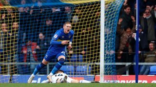 Ronan Curtis celebrates his 94th-minute winner for AFC Wimbledon against MK Dons in March 2024.