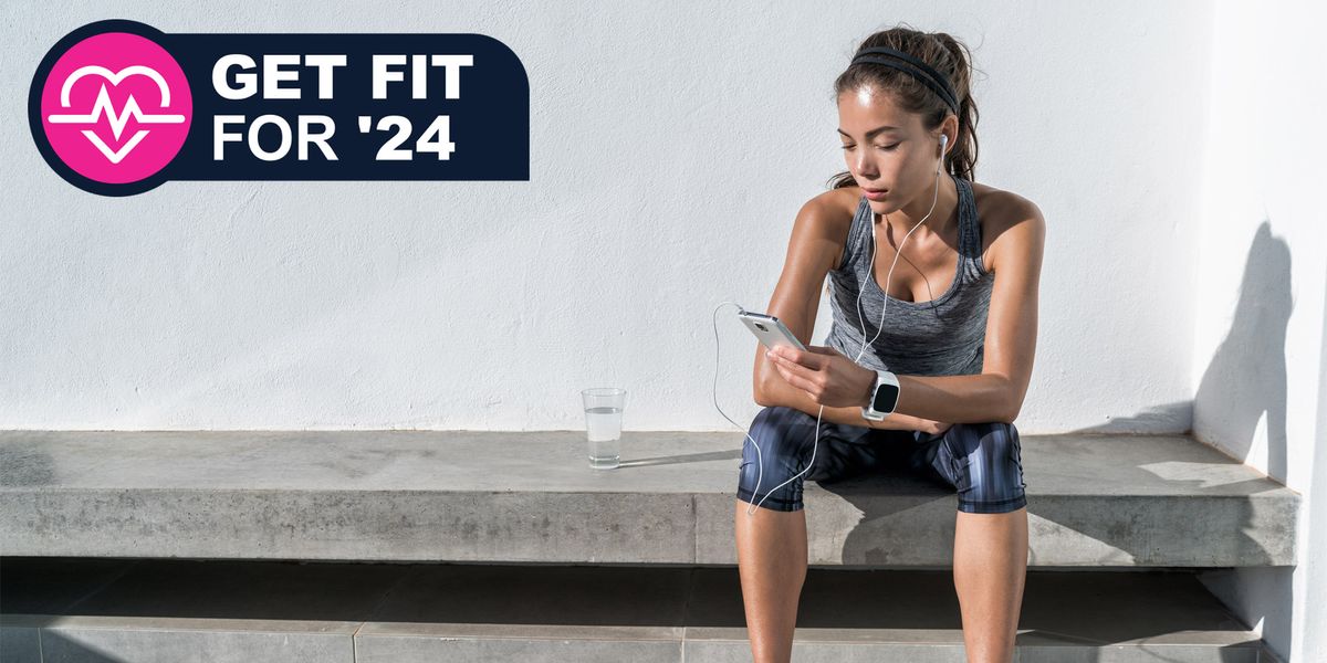 Woman sitting on bench in athleisure using a fitness app