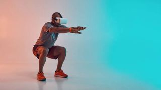 Quest 2 fitness games: a man doing a squat wearing a VR headset
