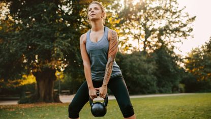 Woman training with a kettlebell outside
