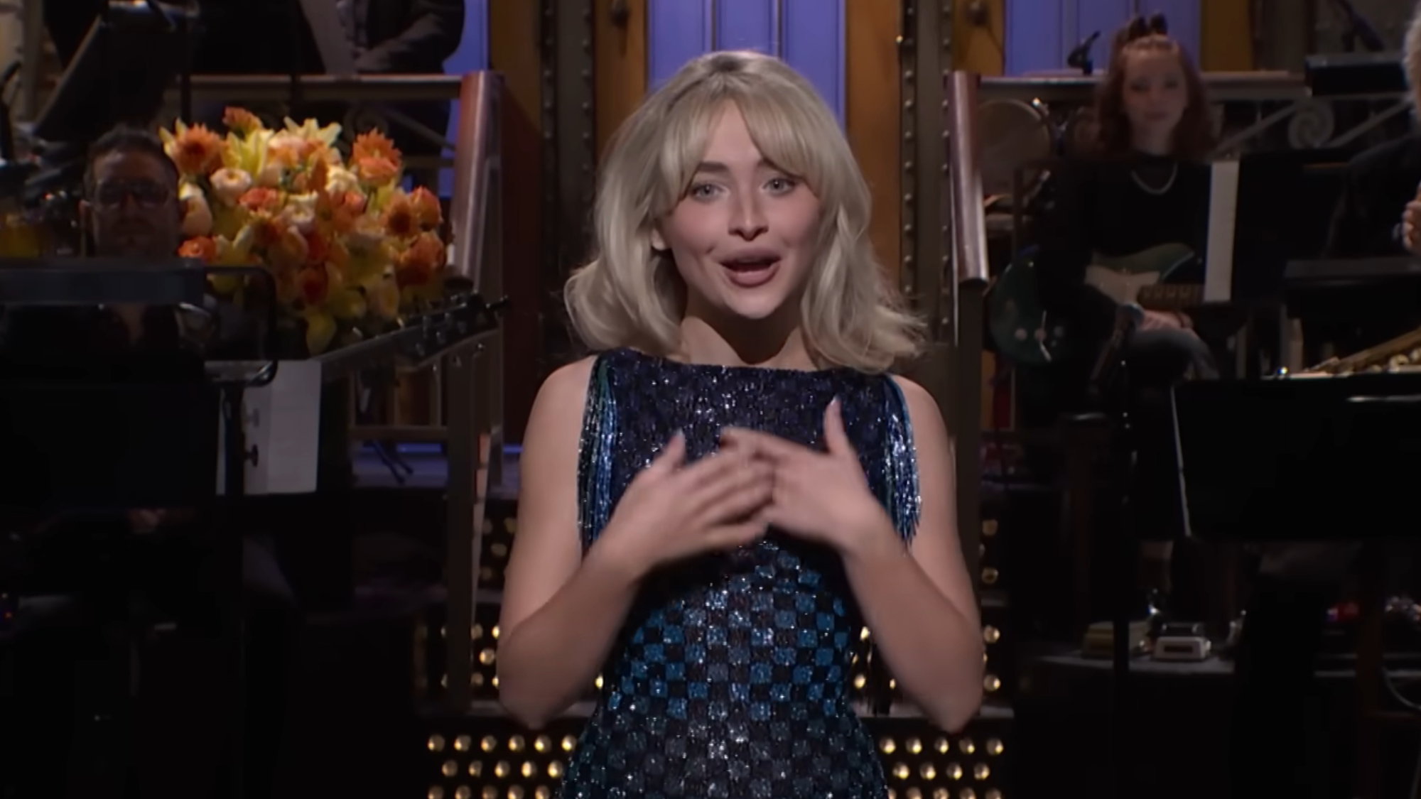 Sabrina Carpenter wears a sparkly dress during her monologue on SNL.