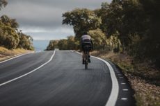 Bikepacking rider on tarmac road