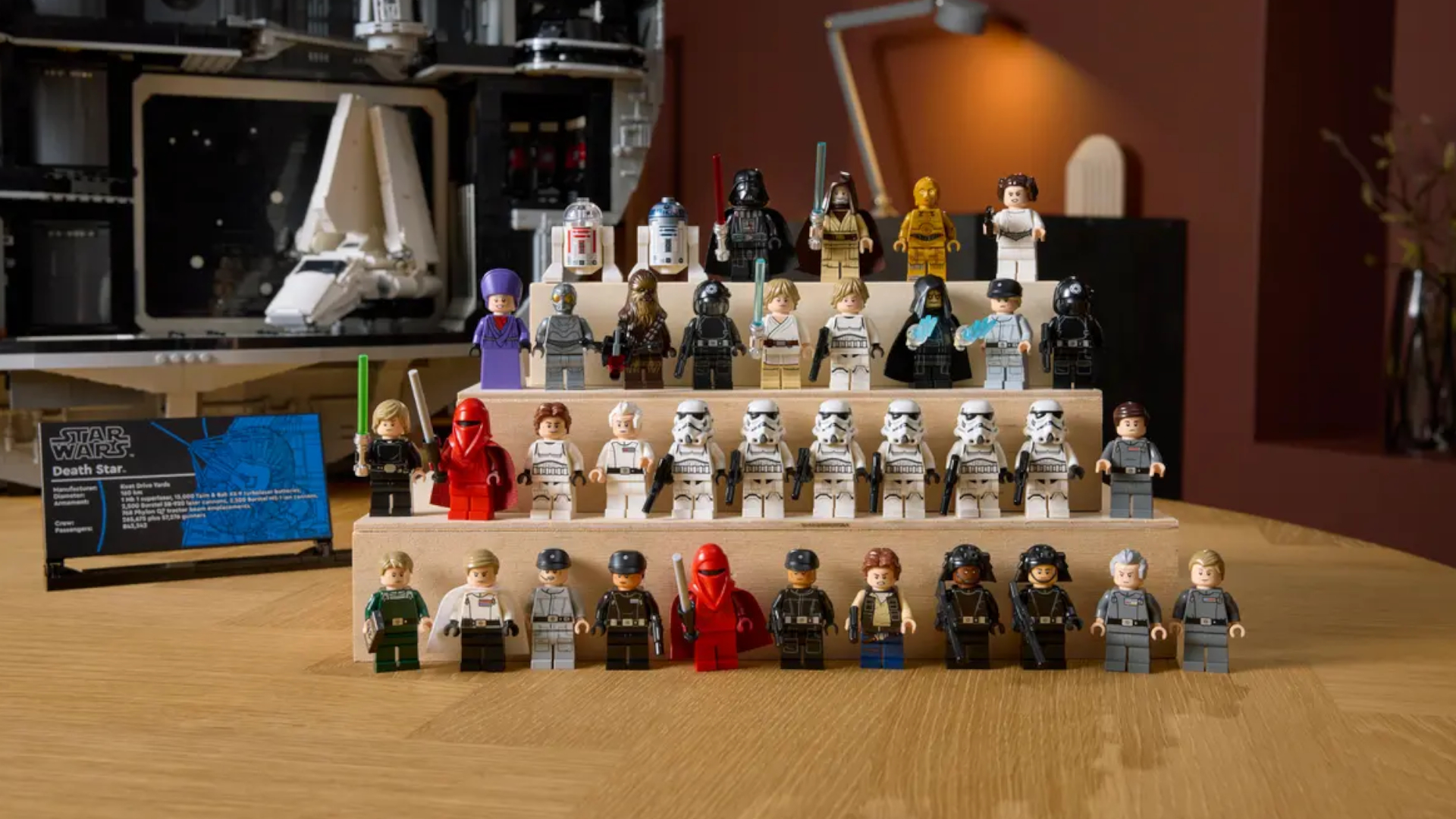 The full array of Lego minifigures included within the Death Star set, with the model itself visible in the background