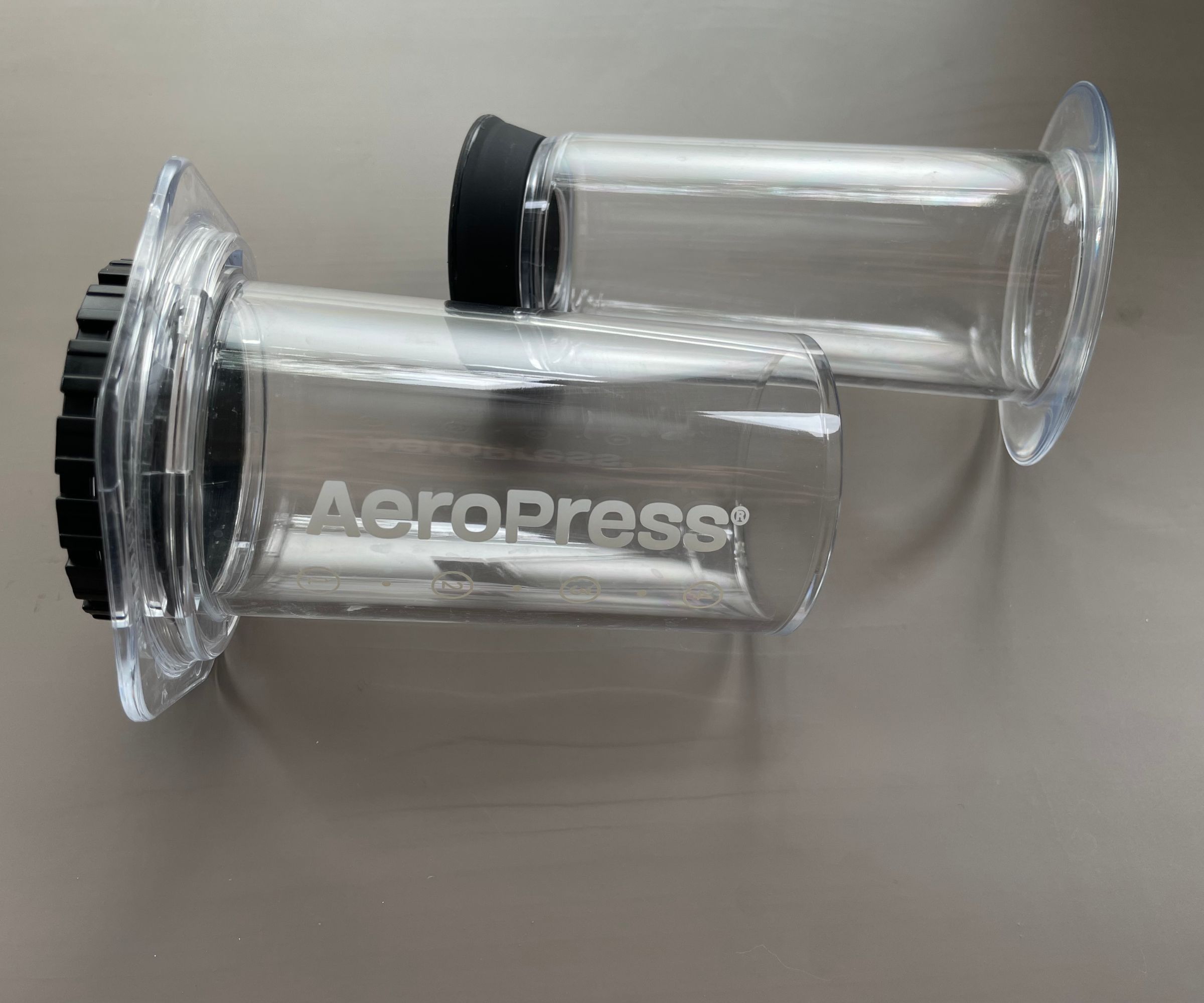 A clear AeroPress in parts on a table, ready to use to make The Ultimate AeroPress Recipe