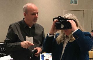 Dr. Street shows attendee Randy Rodgers the VR experience from USC Shoah.