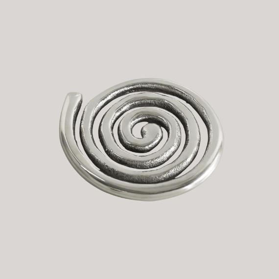 A silver coaster against a pale grey background.