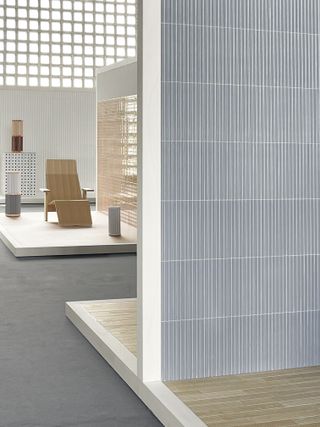 Exhibition view showing Bouroullec pieces, including lounge chair for Mattiazzi, with samples of their Mutina tiles in muted colours such as light blue and beige