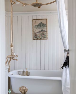 bathroom with white panel wall and bathtub and curtain