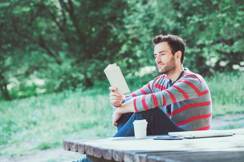 A man reads in a park.