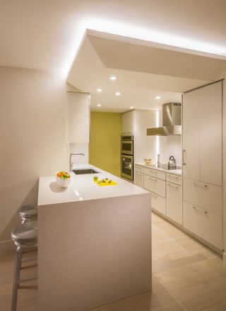 A minimalist kitchen in warm white tones