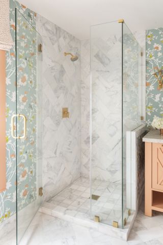 Bathroom with shower with white tile and patterned wallpaper