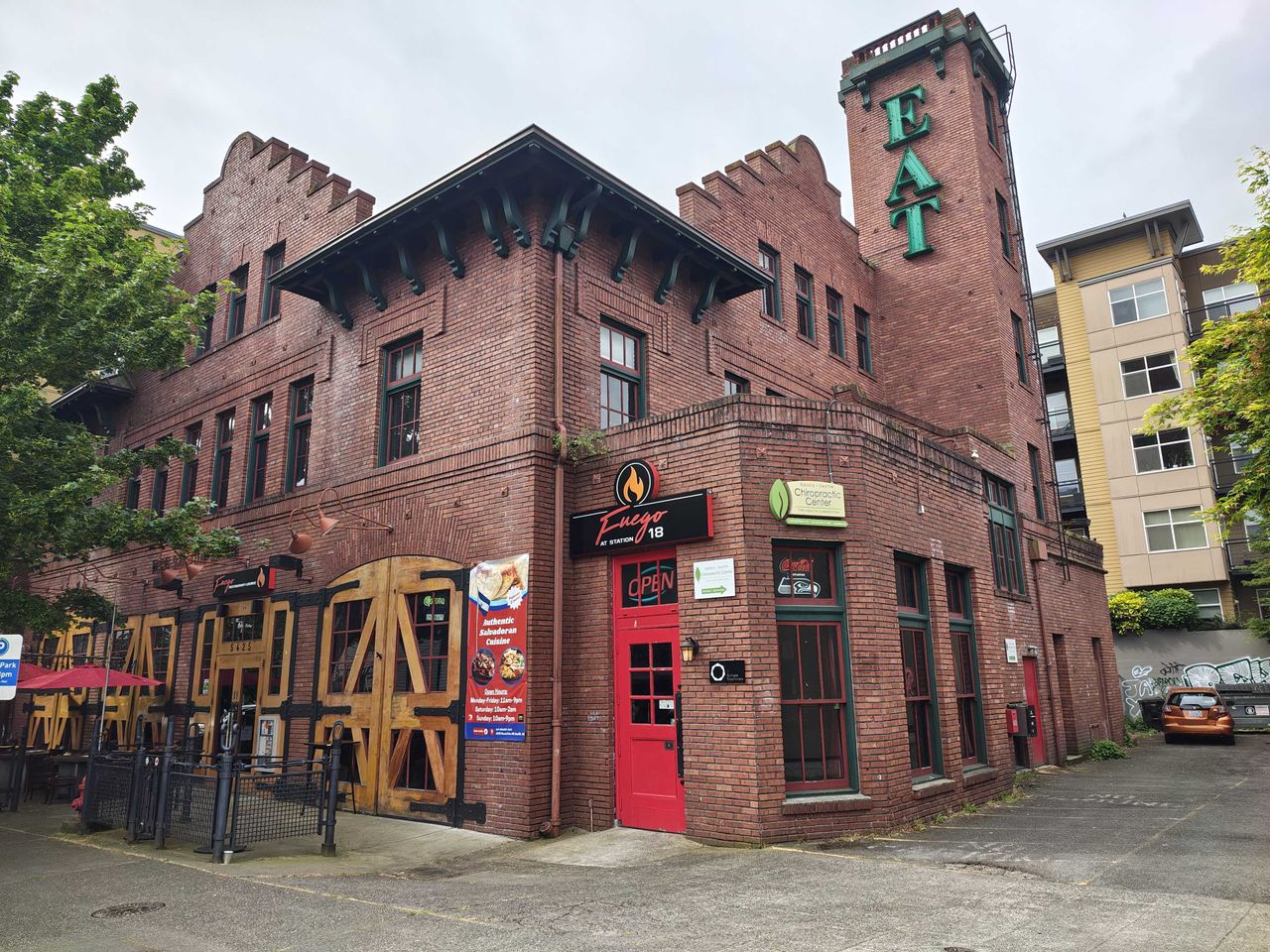 A brick building with a red door