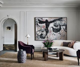 White panelled walls, white sofa, purple armchair