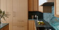 a timber kitchen with a blue green countertop