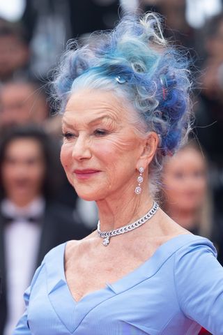 Helen Mirren is pictured with blue hair at the "Jeanne du Barry" Screening & opening ceremony red carpet at the 76th annual Cannes film festival at Palais des Festivals on May 16, 2023 in Cannes, France.