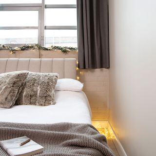cosy bedroom with throw and fairy lights