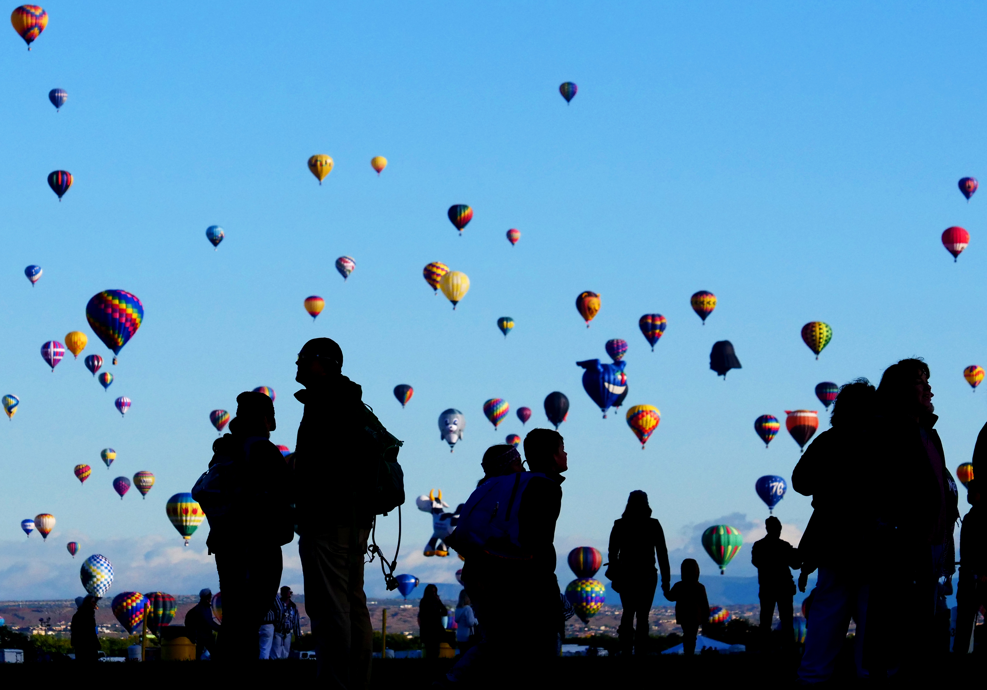 People watch as hot air balloons launch at the Balloon Fiesta in Albuquerque, New Mexico