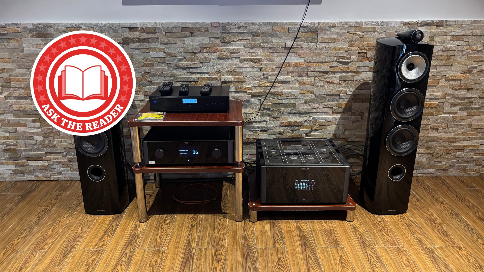 Hi-fi system on wood floor with Ask The Reader logo