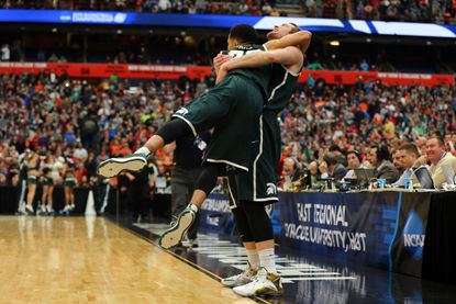 Michigan State Spartans celebrate their upset of Louisville in the NCAA men's basketball tournament