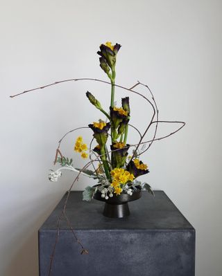 a fresh flower arrangement on a gray pedestal