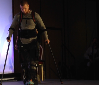 Shane Mosko demonstrates how a new device helps him to walk, at CES 2015.