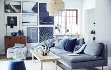 Small blue living room with gallery wall