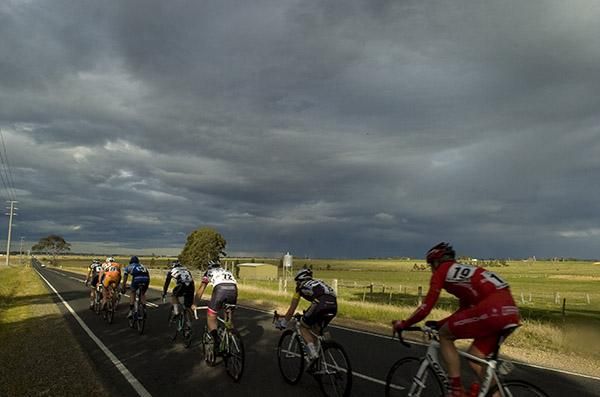 The lead group head towards Maffra beneath grey skies.