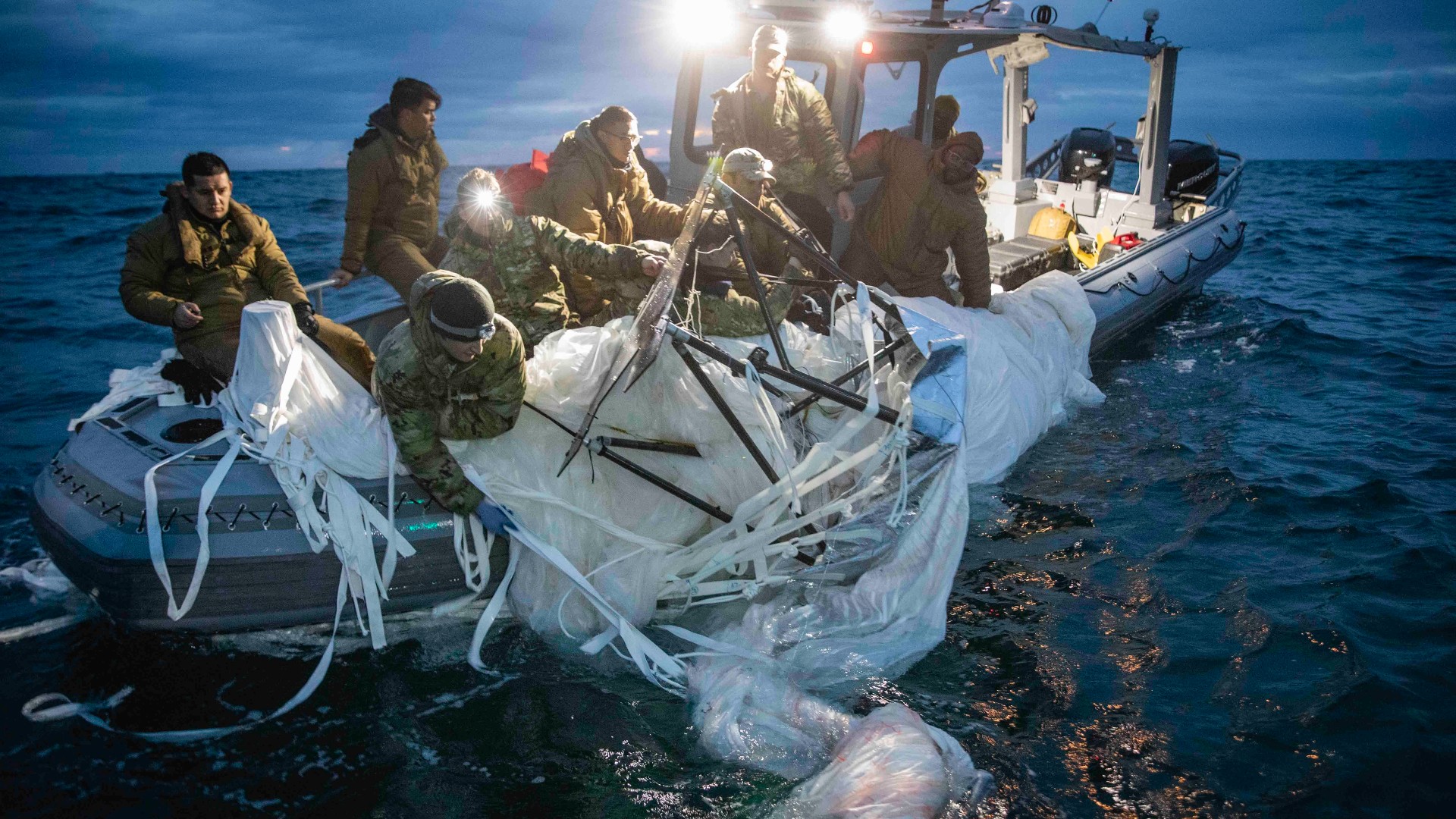 Sailors assigned to Explosive Ordnance Disposal Group 2 recover a high-altitude surveillance balloon off the coast of Myrtle Beach, South Carolina, on February 5, 2023.