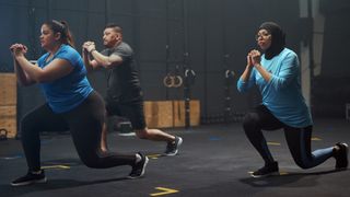 Group of people performing lunges in gym