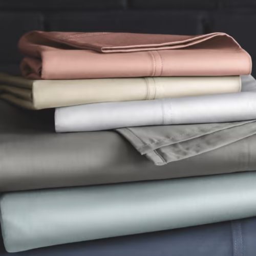 Stack of different colored folded bed sheets