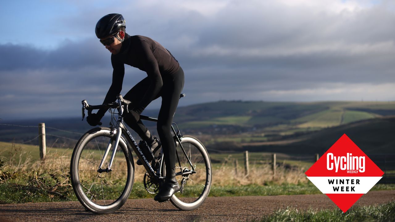 Image shows a cyclist riding through the winter.