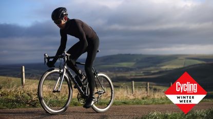 Image shows a cyclist riding through the winter.