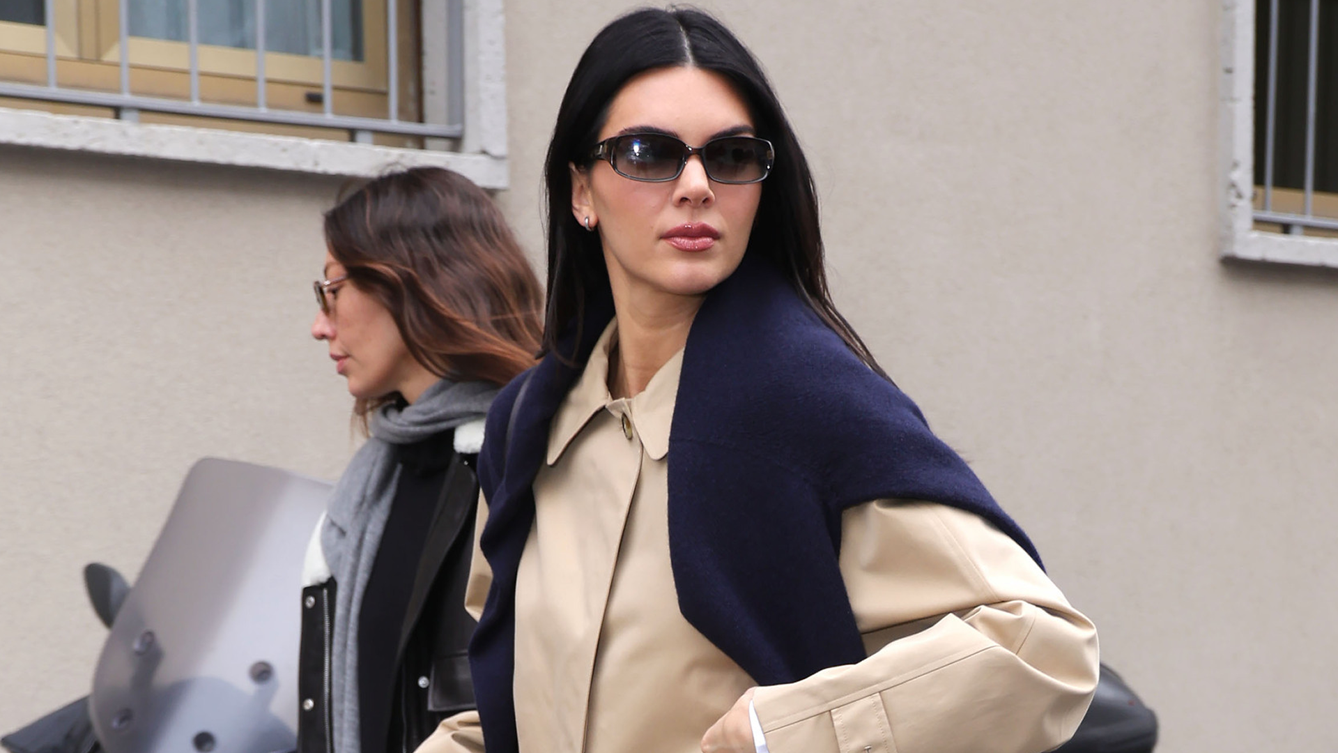Kendall Jenner was spotted at Milan Fashion Week wearing wide-leg white pants, a Burberry trench coat, and the high-vamp flats trend