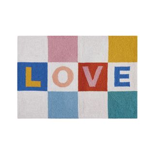 A colorful checkboard rug that says 