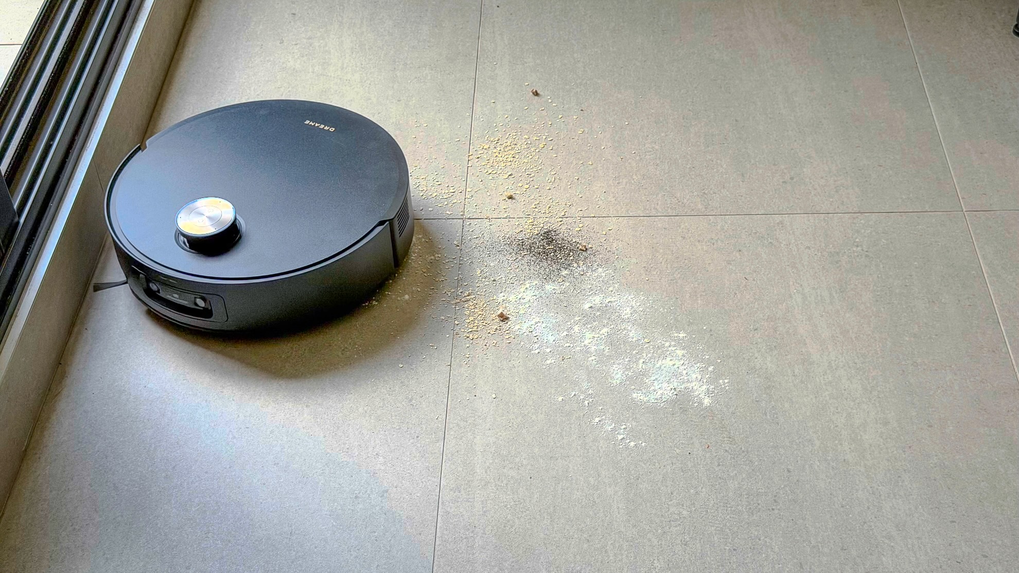 Dreame Aqua10 Ultra robot vacuuming tea, oats and flour on tiles