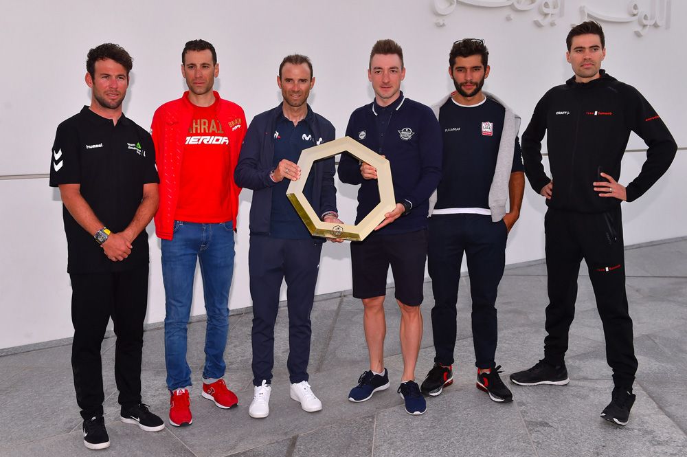 The top riders pose with the gold-plated UAE Tour trophy