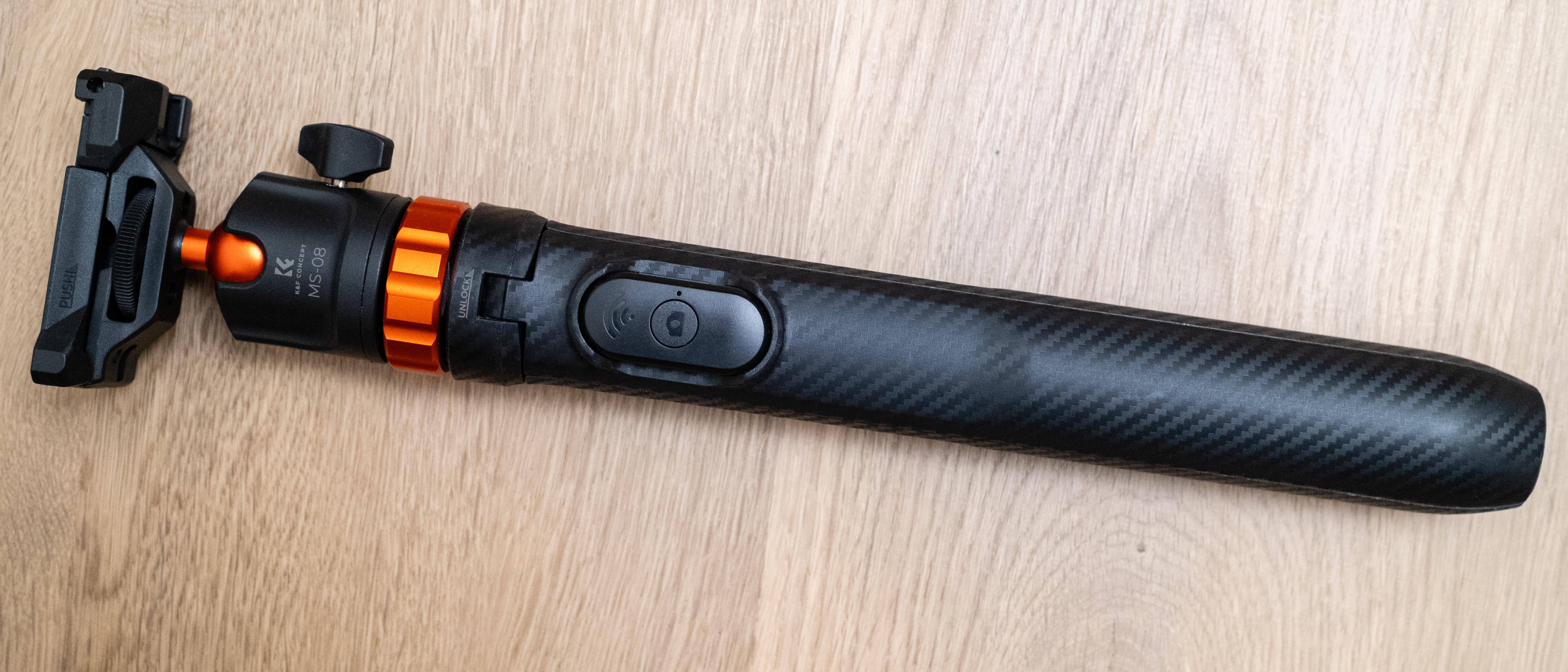 K&amp;F Concept 62-inch 2-in-1 Selfie Stick Tripod folded on a wooden floor