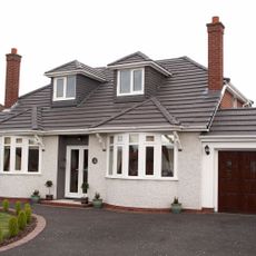 house exterior with white wall and grey slate tiles roof