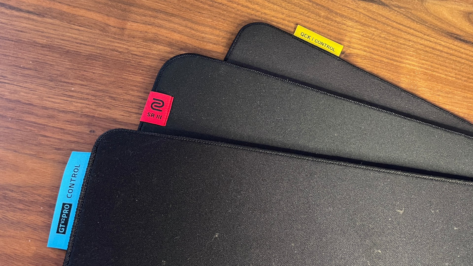 A Razer Goliathus V2 Pro Control, Zowie H-SR III, and Steelseries QcK Performance Control mouse pad, layered on a desk.